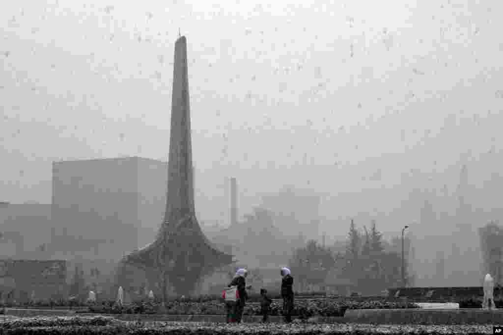 People play in the snow in Damascus as a blustery storm, dubbed Alexa, brought gusty winds, torrential rains and heavy snowfall to most parts of Syria and the entire Middle East, Dec. 13, 2013. 
