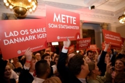 FILE - Supporters of Danish Social Democrats celebrate in the parliament in Copenhagen, Denmark, June 5, 2019.