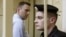 Russian opposition leader and anti-corruption blogger Alexei Navalny (L) leaves after a court hearing in Kirov, April 24, 2013.