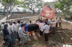People attend the funeral for a demonstrator killed during anti-coup protests, on the outskirts of Yangon, Myanmar, March 27, 2021.
