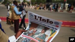 A journalist reads a local newspaper bearing the late Chadian president Idriss Deby on the front page, during the state funeral for Deby in N'Djamena, Chad, April 23, 2021. 