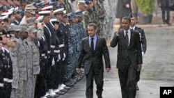U.S. President Barack Obama (R) salutes as he walks with France's President Nicolas Sarkozy during a Franco-American alliance ceremony at the end of the G20 Summit for Heads of State and Government in Cannes, France, November 4, 2011.