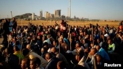 Miners on strike chant slogans as they march in Nkaneng township outside the Lonmin mine in Rustenburg, May 14, 2014. 