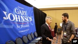 Libertarian presidential candidate Gary Johnson speaks to a delegate at the National Libertarian Party Convention, May 27, 2016, in Orlando, Fla.