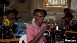 FILE - Eritrean refugees sew cloth during training in the Hitsats refugee camp in the Tigrai region of Ethiopia, Nov. 9, 2017. 