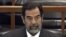 FILE - In this Dec. 6, 2006 file photo, former Iraq leader Saddam Hussein sits in court in Baghdad, Iraq, during the "Anfal" trial against him.