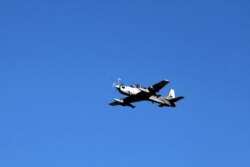 FILE - An Afghan Air Force A-29 attack aircraft flies during an exercise at a bombing range outside Kabul, Afghanistan, Oct. 18, 2016.
