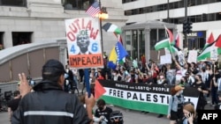 Protesters wave Palestinian flags during a protest to demand reproductive justice, defend the rights of trans and queer people and demand a ceasefire in Gaza on the eve of the Democratic National Convention (DNC) at the United Center in Chicago, Aug. 18, 2024.