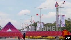 FILE - Workers put finishing touches on the welcoming arch as preparations are underway for the ASEAN leaders' summit and related summits in suburban Pasay city, southeast of Manila, Philippines, Nov. 6, 2017.