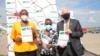 Tanzanian officials and US Ambassador to Tanzania Donald Wright at Julius Nyerere International Airport receive a consignment of COVID-19 vaccine, donated by the US, shipped by Emirates through the AU COVAX facility.