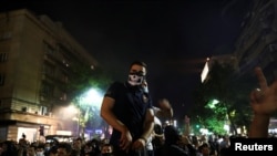 A demonstrator stands during an anti-government rally, amid the spread of the coronavirus disease, in front of the parliament building in Belgrade, Serbia, July 8, 2020. 