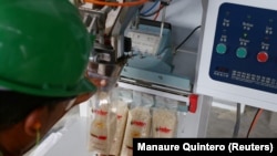 A worker packs rice in the Hugo Chavez rice plant in Tucupita, Venezuela November 27, 2018.