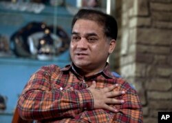 FILE - Ilham Tohti, an outspoken scholar of China's Turkic Uighur ethnic minority, speaks during an interview at his home in Beijing.