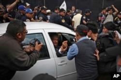 Mexico's President-elect Andres Manuel Lopez Obrador greets a supporter as he leaves the National Palace where he met with Mexico's President Enrique Pena Nieto in Mexico City, July 3, 2018.