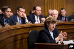 FILE - Phoenix prosecutor Rachel Mitchell questions Christine Blasey Ford as, from left, Sen. Ben Sasse, R-Neb., Sen. Ted Cruz, R-Texas, Sen. Mike Lee, R-Utah., and Sen. John Cornyn, R-Texas, listen during the Senate Judiciary Committee hearing, Sept. 27, 2018.