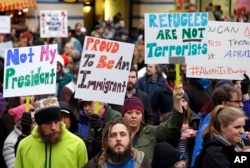 FILE - People begin to gather before a rally protesting President Donald Trump's travel ban on refugees and citizens of seven Muslim-majority nations, Jan. 29, 2017.