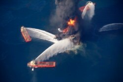 FILE - The Deepwater Horizon oil rig burns in the Gulf of Mexico following an explosion that killed 11 workers and caused the worst offshore oil spill in the nation's history, April 21, 2010.