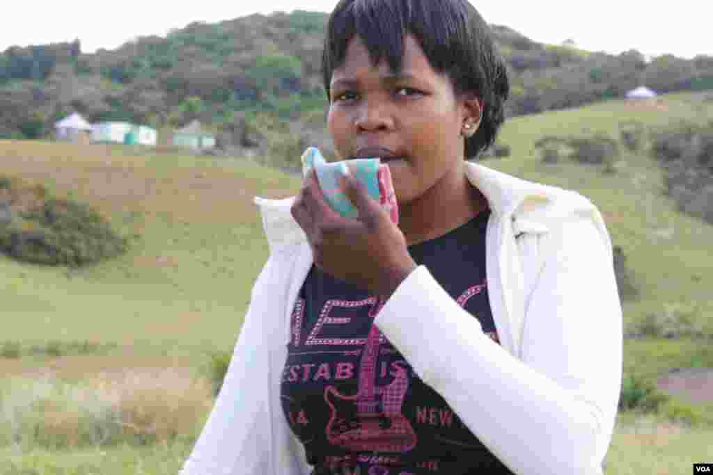 Senyuko is coughing up blood, so she holds a cloth in front of her mouth. (VOA/D. Taylor)