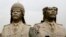FILE - U.S. Army soldiers stroll past two bronze busts of former Iraqi president Saddam Hussein in the Green Zone in Baghdad, March 20, 2009, the sixth anniversary of the U.S.-led invasion of Iraq.