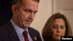 Virginia Governor Ralph Northam, accompanied by his wife Pamela Northam, announces he will not resign, during a news conference in Richmond, Virginia, Feb. 2, 2019.