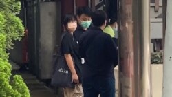 This video frame grab taken from AFPTV footage shows Chow Hang-tung (L), barrister and a leader of the Hong Kong Alliance in Support of Patriotic Democratic Movements of China, being led away by plainclothes police officers after being detained in…
