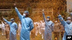 An Indian Air Force helicopter showers flower petals on the staff of INS Asvini hospital in Mumbai, India, May 3, 2020.