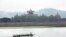 A boat on the Mekong River passes Chinese-run Kings Roman Casino in the special economic zone in Laos. (D. Schearf/VOA)