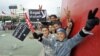 Young Tunisian boys make victory signs during a gathering as part of the festivities marking the second anniversary of the uprising that ousted long-time dictator Zine El Abidine Ben Ali, in Tunis, January 14, 2013.