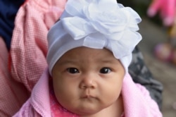 FILE - An Indonesian toddler waits to be circumcised in Bandung, Indonesia, Feb. 10, 2013.