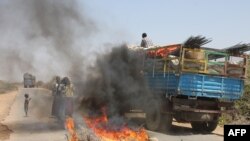 A truck passing a partial roadblock setup by residents as a protest against the Islamist Al-Shabab insurgent group, in Tobanka Buundo in the lower Shabelle region, near the Somalian capital Mogadishu, March 6, 2014.
