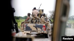 FILE - A Nigerian army convoy vehicle with an anti-aircraft gun drives toward Bama, Borno State, Nigeria, August 31, 2016. 