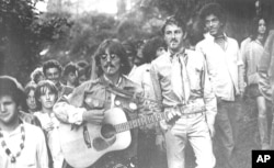 FILE - George Harrison, a member of the British pop group, the Beatles, pays a surprise visit to San Francisco's famed Haight-Ashbury hippy district, Aug. 8, 1967.