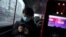A passenger wearing a face mask checks his mobile phone on a bus, following an outbreak of the novel coronavirus in the country, in Beijing, China, Feb. 21, 2020. 