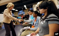 FILE - Massachusetts Democratic gubernatorial candidate Martha Coakley, left, greets participants as she arrives for a youth vote forum at the Service Employees International Union office in Boston.