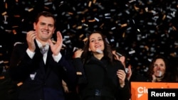 Catalan Ciudadanos leader Ines Arrimadas, center, smiles next to Ciudadanos national leader Albert Rivera at a Ciudadanos rally after results were announced in Catalonia's regional elections in Barcelona, Spain, Dec. 21, 2017.