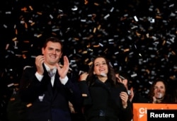Catalan Ciudadanos leader Ines Arrimadas, center, smiles next to Ciudadanos national leader Albert Rivera at a Ciudadanos rally after results were announced in Catalonia's regional elections in Barcelona, Spain, Dec. 21, 2017.