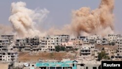 Smoke rises after airstrikes on a rebel-held part of the southern city of Dara'a, Syria, June 15, 2017. 