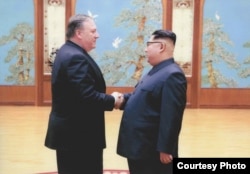 FILE - A U.S. government handout photo shows then-Central Intelligence (CIA) Director Mike Pompeo meeting with North Korean leader Kim Jong Un in Pyongyang, North Korea.