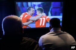Egypt soccer fans watch Russia score during the World Cup match between Russia and Egypt, in Sao Paulo, Brazil, June 19, 2018.