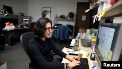 FILE - DACA recipient Javier Hernandez Kistte works at his job in visual effects in Los Angeles, Jan. 24, 2018. He said he had been struggling with stress and depression during the debate over DACA.