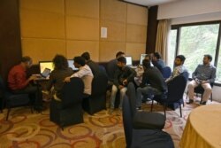 Journalists use internet facilities sanctioned by the authorities, amid strict communications restrictions, during a lockdown at a hotel in Srinagar, Oct. 3, 2019.