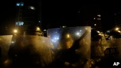 FILE - Ecuadorian police in riot gear. Ecuador's president, Rafael Correa, declared a 30-day state of emergency in Morona Santiago province, home to the Panantza-San Carlos exploration project operated by the ExplorCobres company. His government said "illegally armed groups" protested against the project on Wednesday.