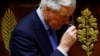 French Prime Minister Michel Barnier removes his glasses after he delivered a speech during a debate on a no-confidence motion in the National Assembly, which then approved the motion on Dec. 4, 2024.