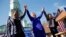 Democratic presidential candidate Hillary Clinton, center, celebrates at a rally with Rep. Karen Bass, D-Calif., left, and Rep. Maxine Waters, D-Calif., Monday, June 6, 2016.