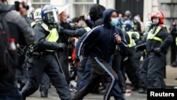 Demonstrators clash with police officers on Whitehall during a Black Lives Matter protest near Downing street in London, following the death of George Floyd who died in police custody in Minneapolis, June 6, 2020.