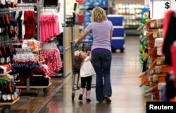 FILE - A woman shops with her daughter at a Walmart Supercenter in Rogers, Arkansas.