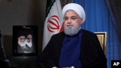 In this photo released by official website of the office of the Iranian Presidency, President Hassan Rouhani addresses the nation in a televised speech in Tehran, Iran, Monday Aug. 6, 2018.