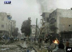 In this photo provided on Jan. 3, 2018 by the Syrian anti-government activist group, Edlib Media Center, EMC, which has been authenticated based on its contents and other AP reporting, shows members of the Syrian civil defense known as the White Helmets,