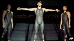 American Olympic medalists Amanda Beard, left, Natalie Coughlin, right, and Michael Phelps pose in the high-tech Speedo LZR Racer swimsuits worn at the 2008 Beijing Summer Olympics.