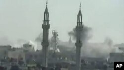 Image taken from YouTube on April 17, 2012, shows smoke rising from reported shelling by Syrian government forces on the district of Khalidiya in the flashpoint central city of Homs